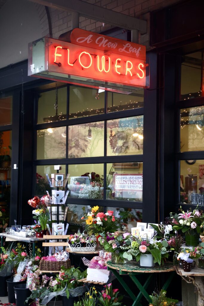 A New Leaf Flowers hangs over the dashes of red, white and pink strewn throughout bouquet designs.