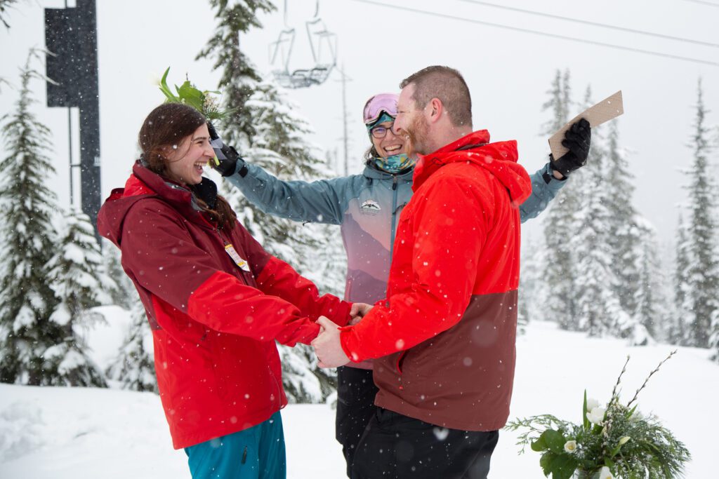 Gwyn Howat declares Madison, left, and Sam Lidgard husband and wife at Mount Baker Ski Area as snow falls.