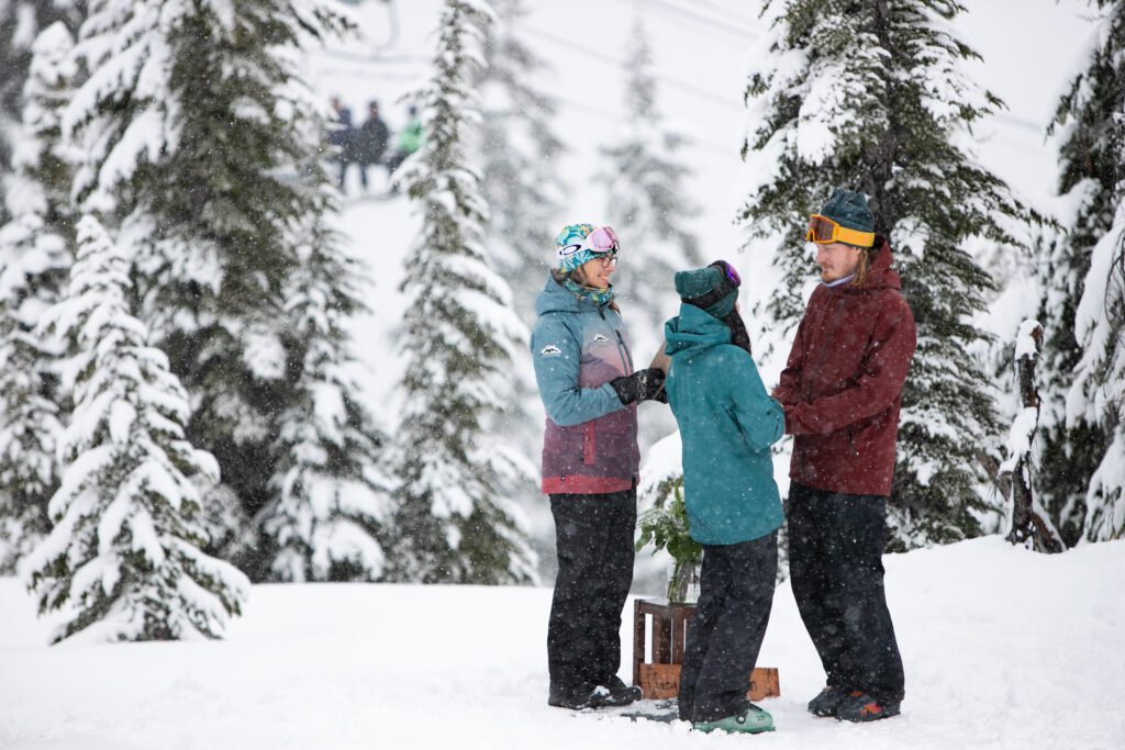 Maeghan Scott and Brian Hueber say vows in a commitment ceremony as snow falls around them.