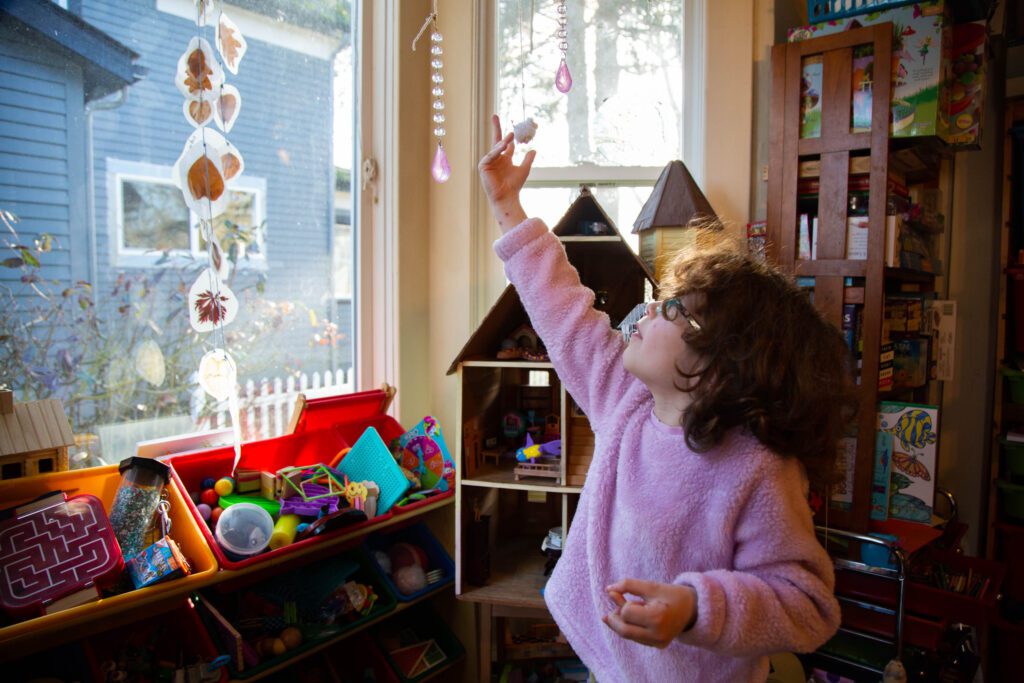 Coramina Schrengohst shows off a hanging craft project hanging near the toys.