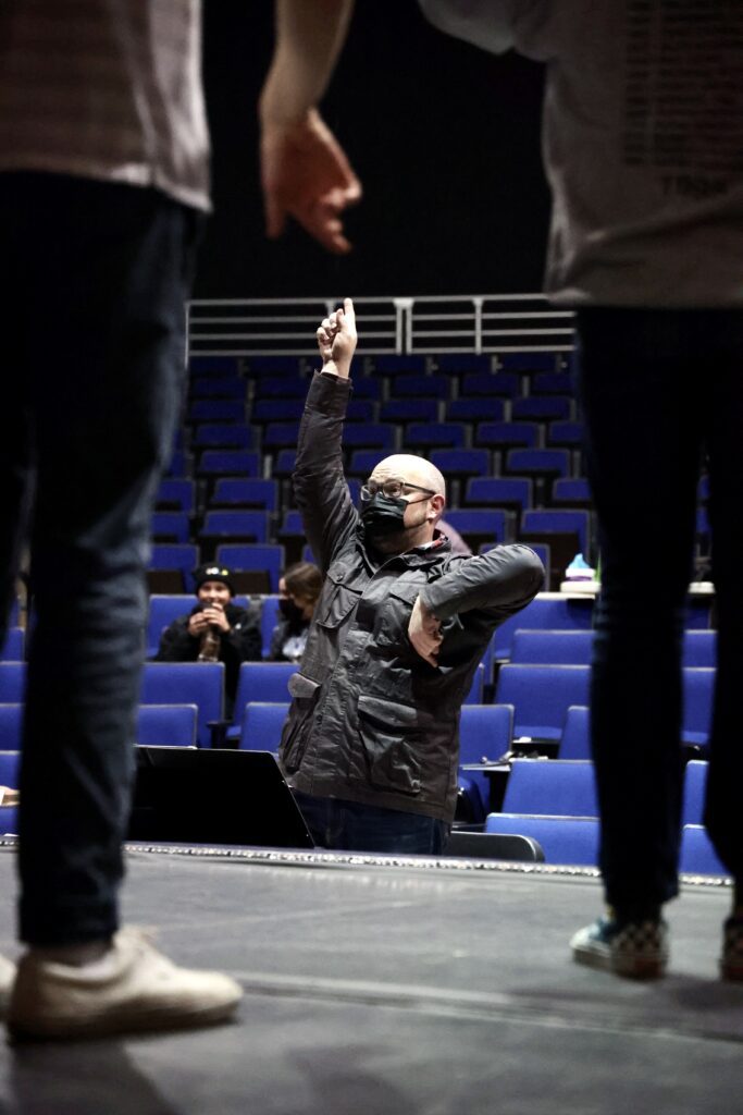 Jason Parker, director of "Big Fish" and Squalicum High School drama teacher, directs the cast as he directs with his hands.