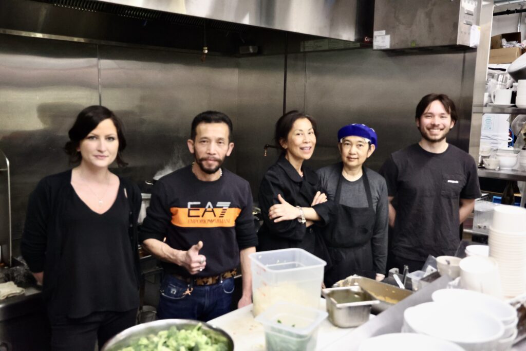 From left, server Leslie Horton, sou-chef Arunsak Seetaphawang, head chef Usanee Klimo, sous-chef Naphada Ngoenjan and server Pierce Bock stand side by side inside the Maikham's kitchen.