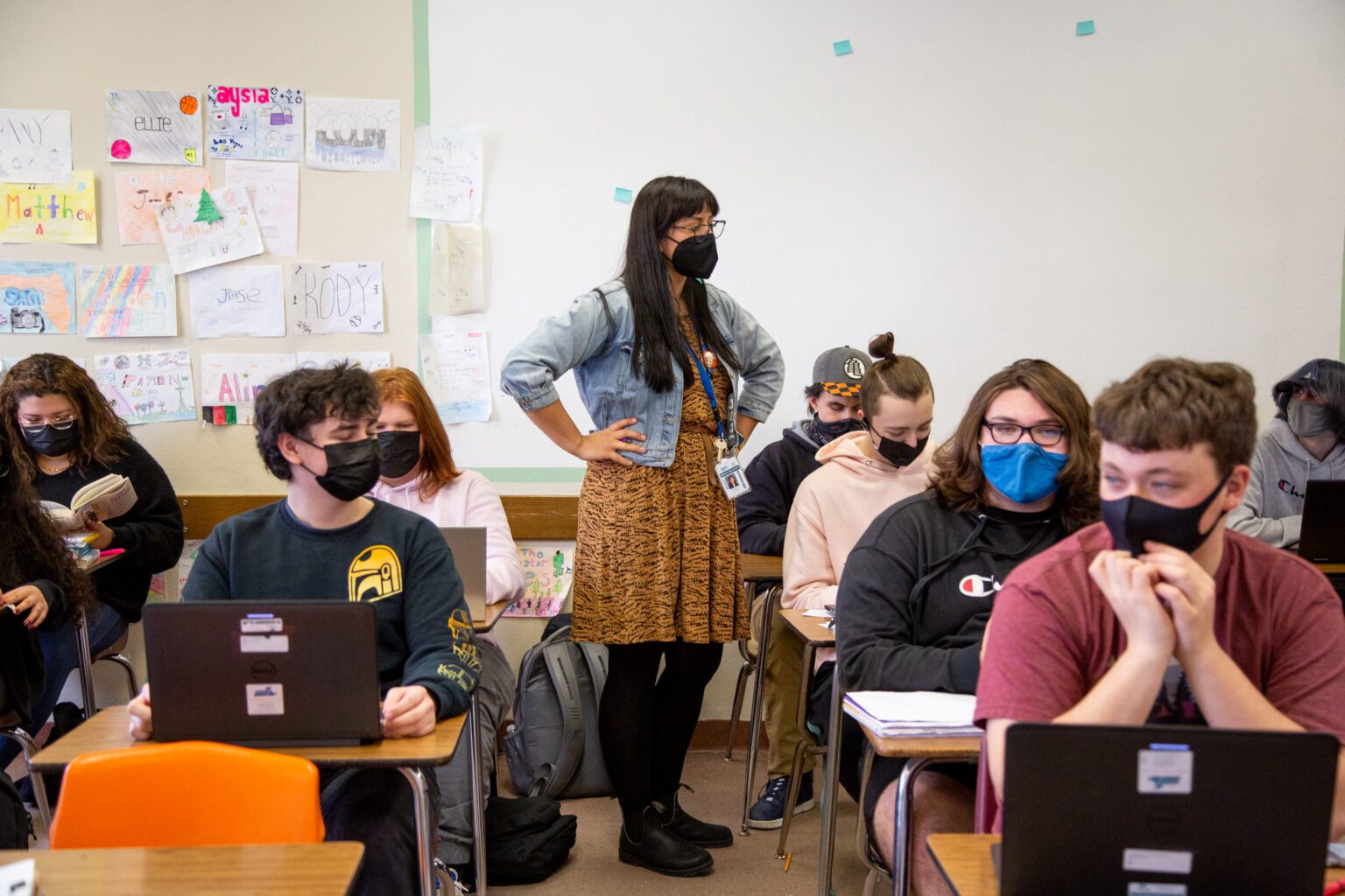 Ferndale High School teacher Victoria Caswell helps students finish reports in her classroom while everyone wore masks.