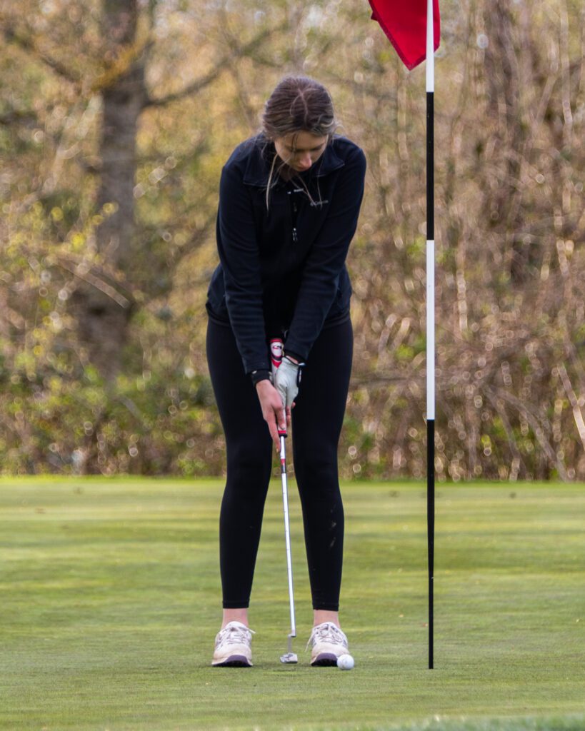 Nooksack Valley's Samantha Howe gets ready to putt the golf ball.