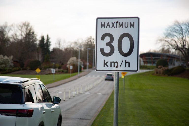 A road sign notifies visitors of the speed cap.