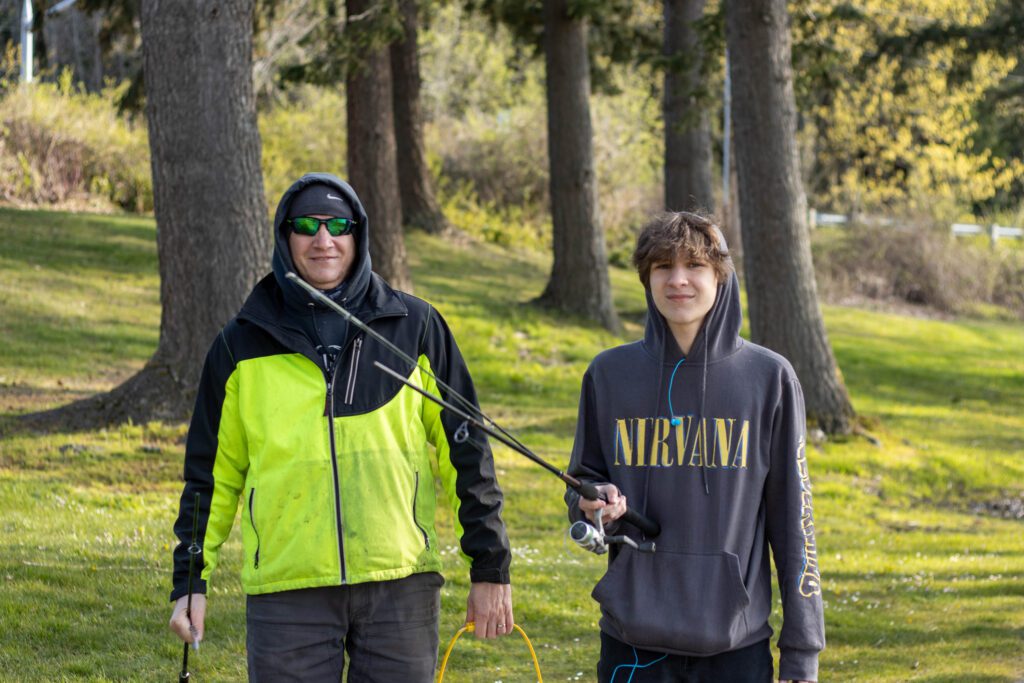 Terry Sharp and his son Conner, 17, walk back to their car with their fishing poles after a morning of fishing.