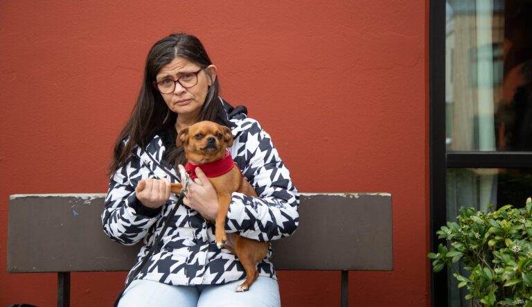 Shaylene Wright holds her service dog, Oscar.