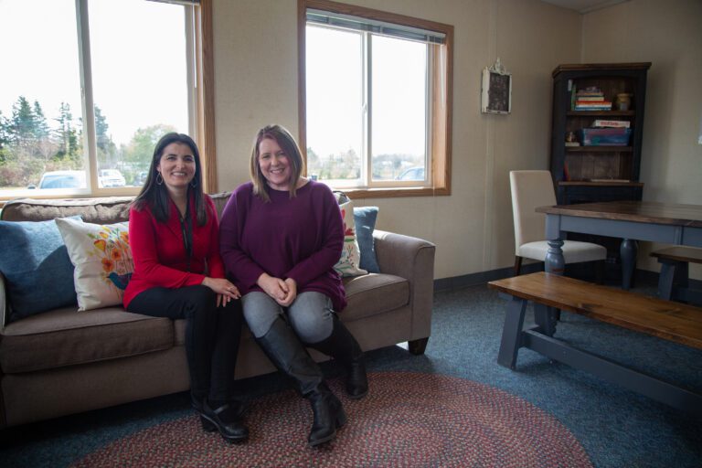 Cultural liaison Elvira Rozen and family services coordinator Alicia Roberts sit on the couch in Meridian School District's new Family Resource Center.