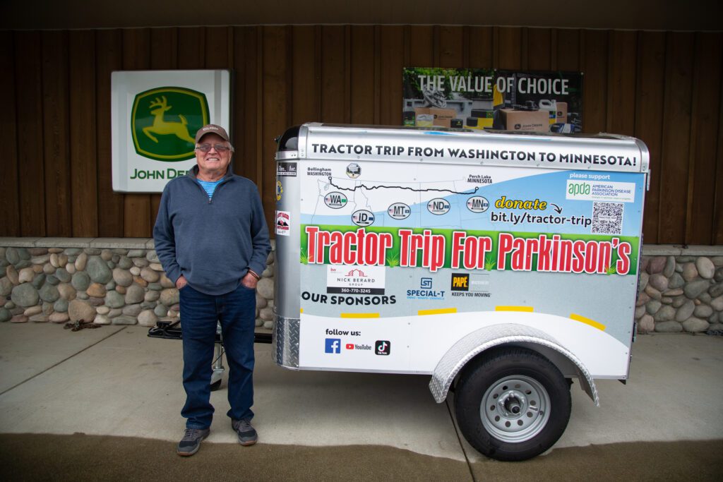 Mike Adkinson stands next to his trailer.