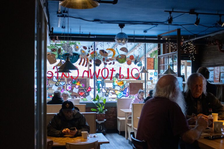 The Old Town Cafe interior with several customers seated and enjoying their meals.