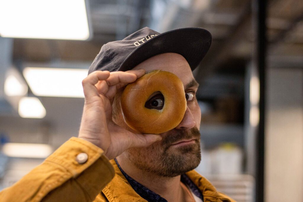 Bayly Peterson, pictured, looks through the bagel hole.