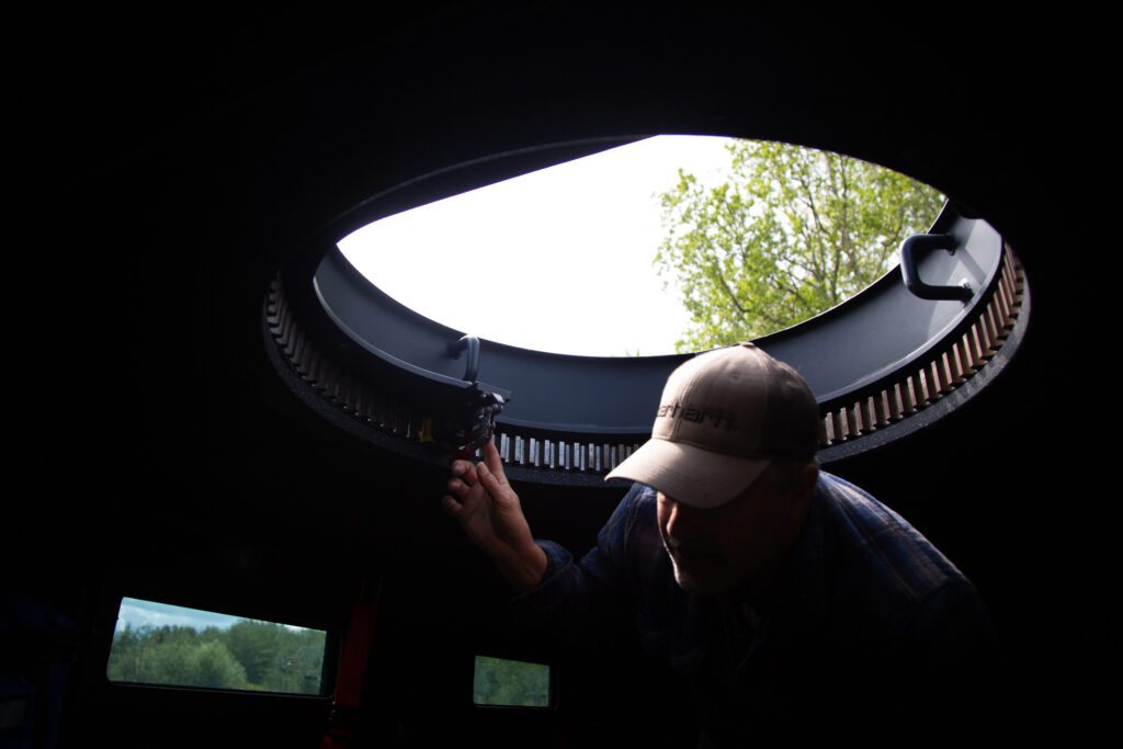 Officer Jeff Hinds ducks down from the hatch in the roof of the Bearcat.