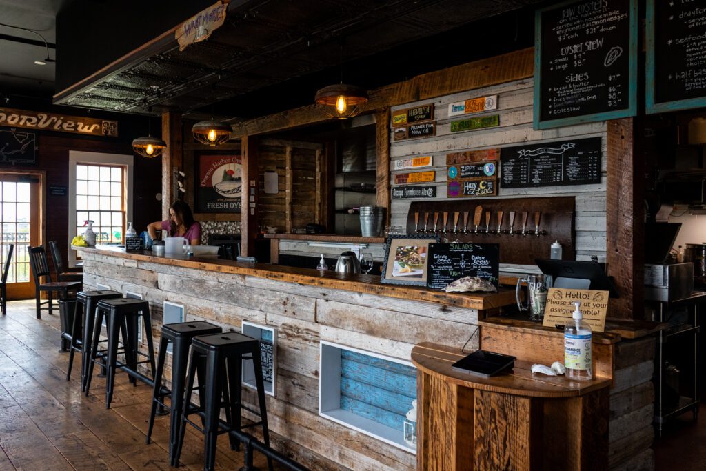 The Drayton Harbor Oyster Company restaurant interior with multiple bar seats along the counter.