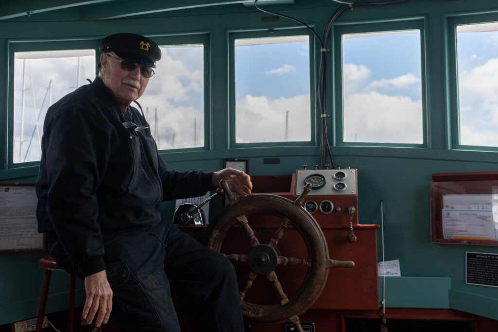 Richard Sturgill stands next to the steering wheel for the ferry.