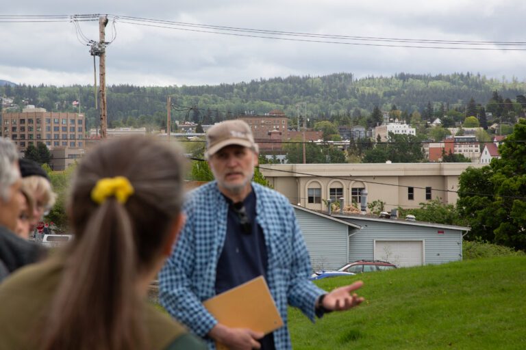 Lettered Streets residents including Geoff Vogel, right, discuss as he gestures with one hand.