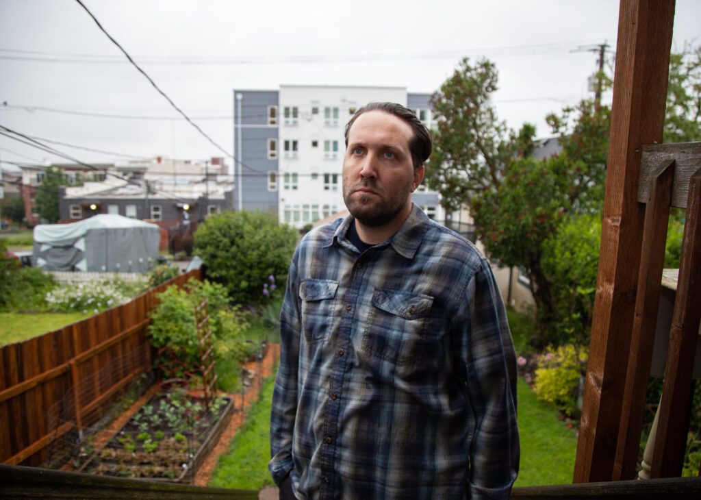 Ben Brown stands in the backyard of his home.