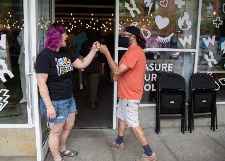 WinkWink Boutique employee Tiffany Geaudreau fist-bumps a supporter as they enter the store.