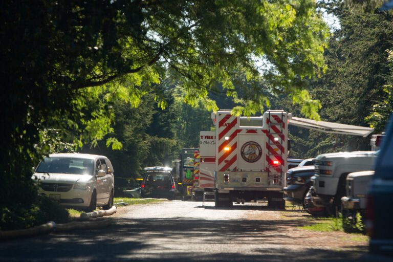 An ambulance drives away in a residential area.