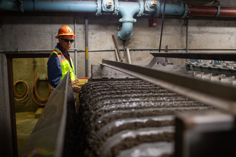 Bellingham Mayor Seth Fleetwood looks at the pipes near a gravity belt sludge device at the Post Point wastewater treatment plant.