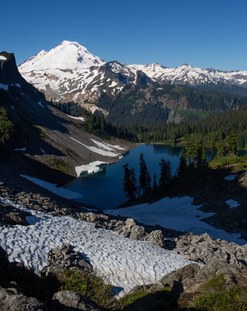 The peak of Herman Saddle overlooking the Iceberg Lake and Mount Baker.