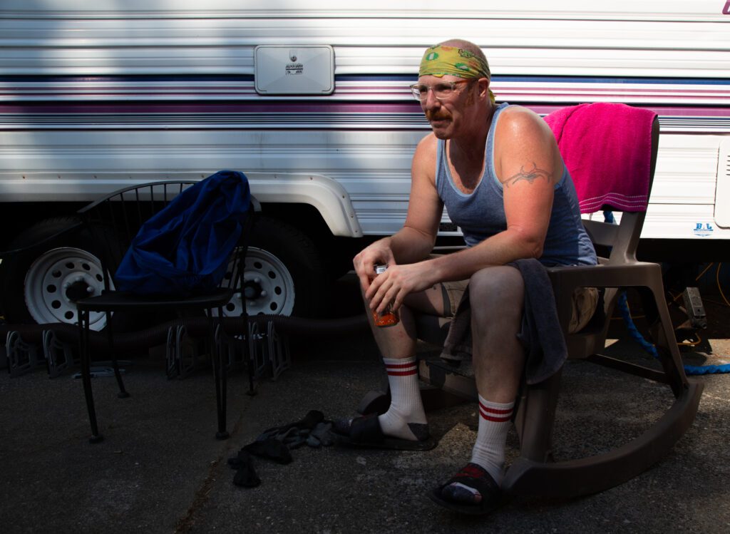 Levi Brown sits outside of his trailer, parked in the Browns' front yard.