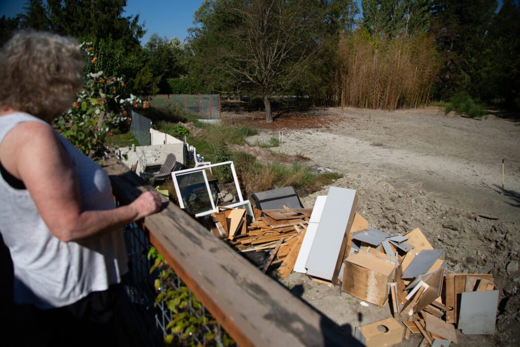 Cheryl Brown overlooks cabinets thrown from the basement of her home.