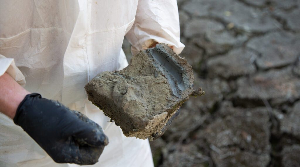 Levi Brown holds a chunk of clay pulled from the family's backyard.