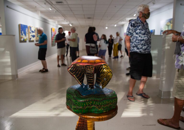 Dozens of people mill around Gallery Syre looking at paintings and sculptures by Francis Xavier Donovan, Anita H. Lehmann, Bonnie Smerdon and David Syre.