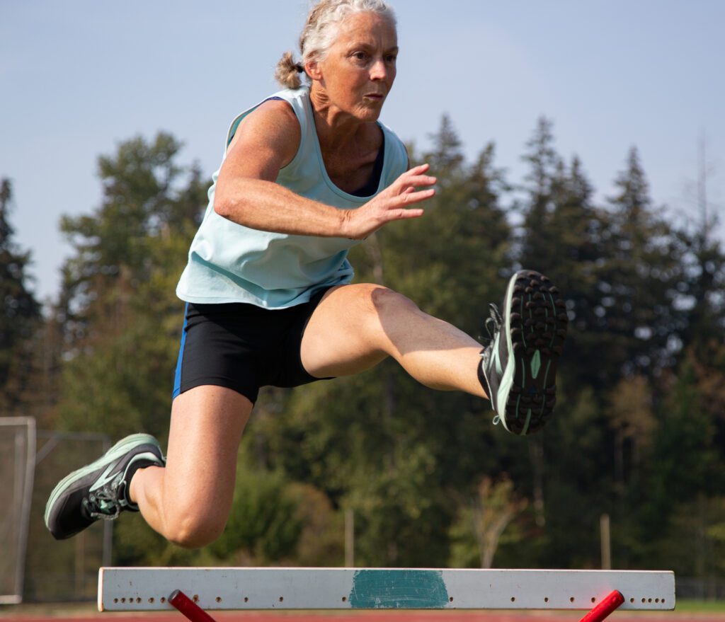 Daphne Scott clears a hurdle while training.