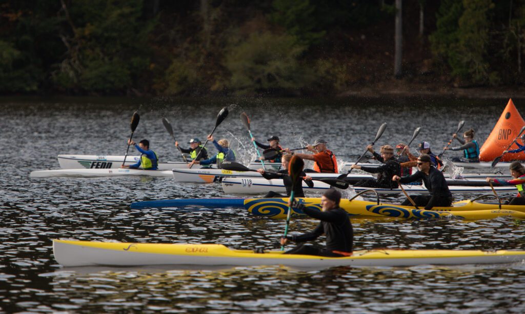 Ana Swetish and a dozen other kayakers begin at the starting like alongside competitors.