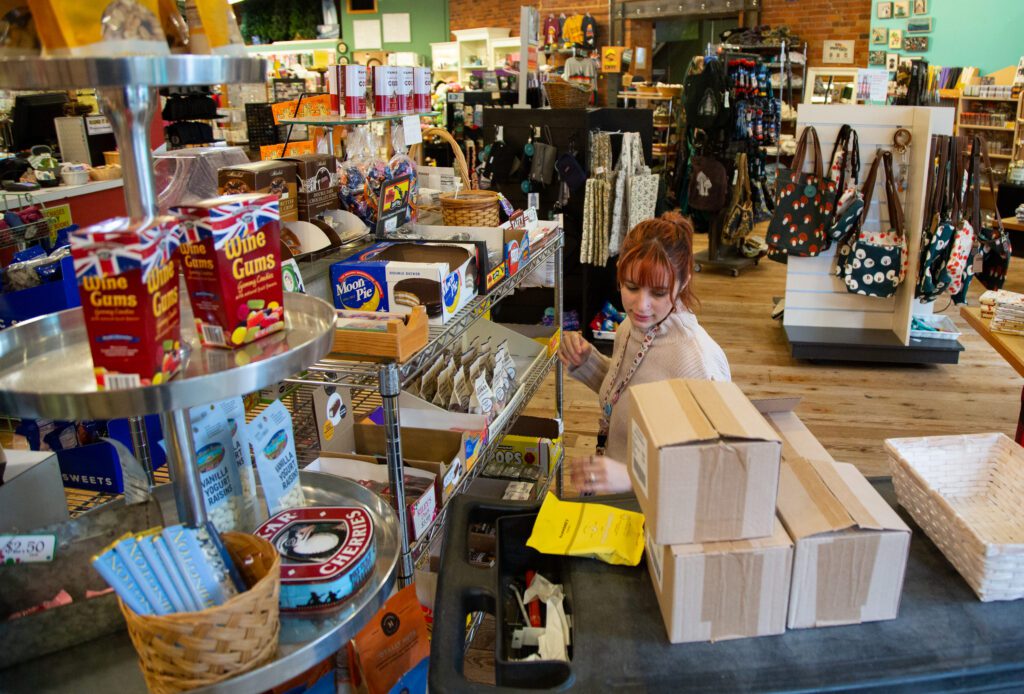 Bookseller Anna Brown restocks candy shelves at Paper Dreams.