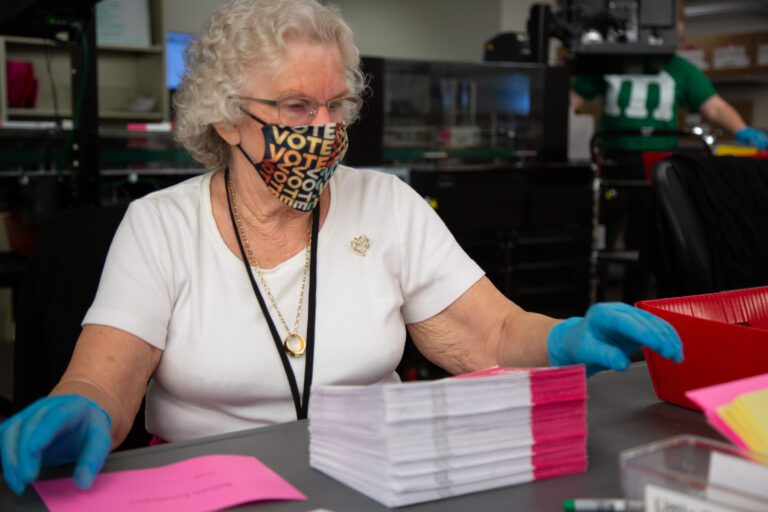 Judy Slotemaker processes ballots at the Whatcom County Auditor's Office.