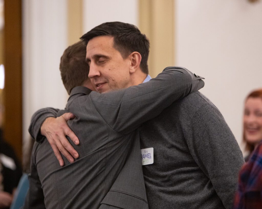 Joe Timmons, left, and Rep. Alex Ramel hug at Hotel Leo.