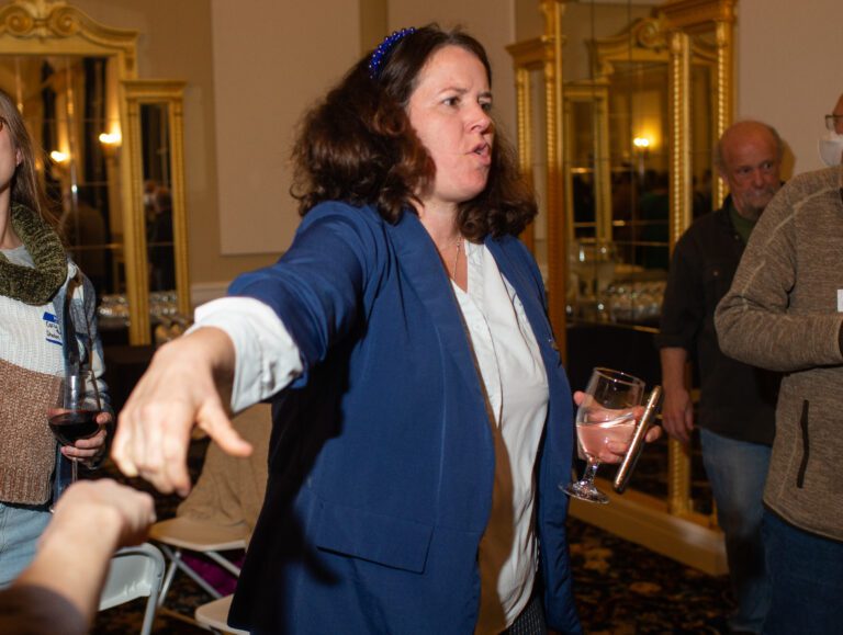 Then-Rep. Sharon Shewmake receives a congratulatory fist bump after receiving the first round of election results inside Hotel Leo.