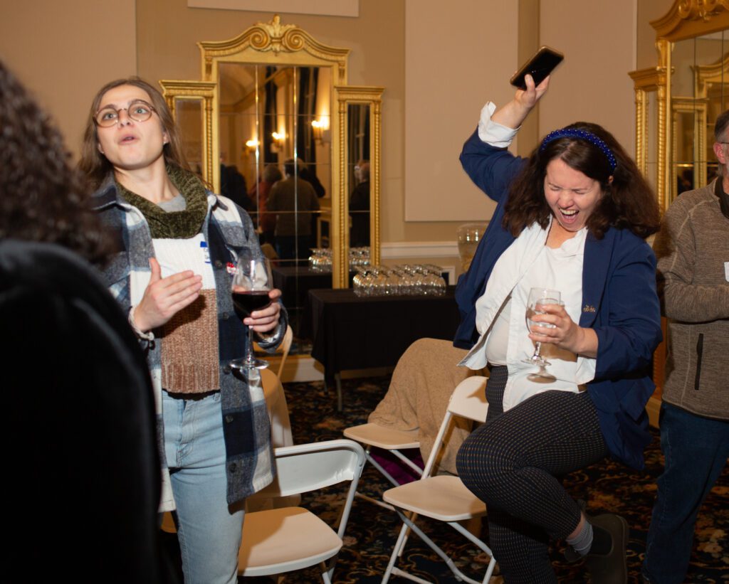 Rep. Sharon Shewmake, right, celebrates after checking preliminary results at Hotel Leo.