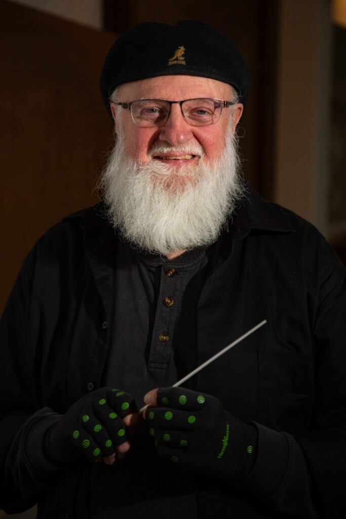 Frank Kuhl, director and conductor for the Bellingham Community Band, holds a conductors stick.