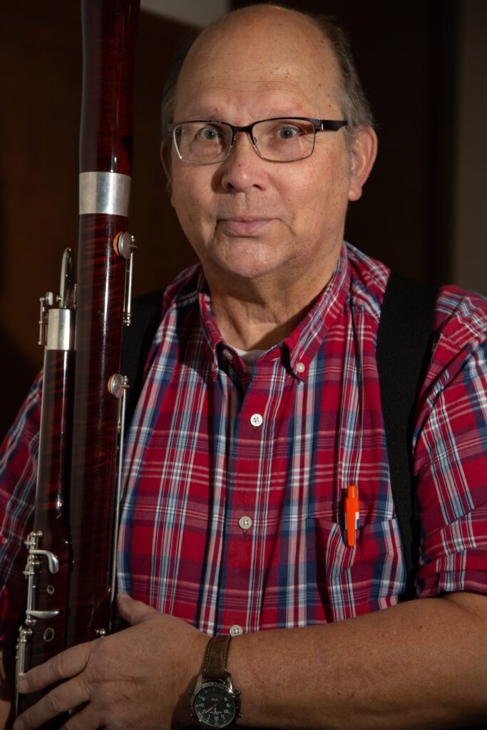 Timothy Whiteman holds up his bassoon.