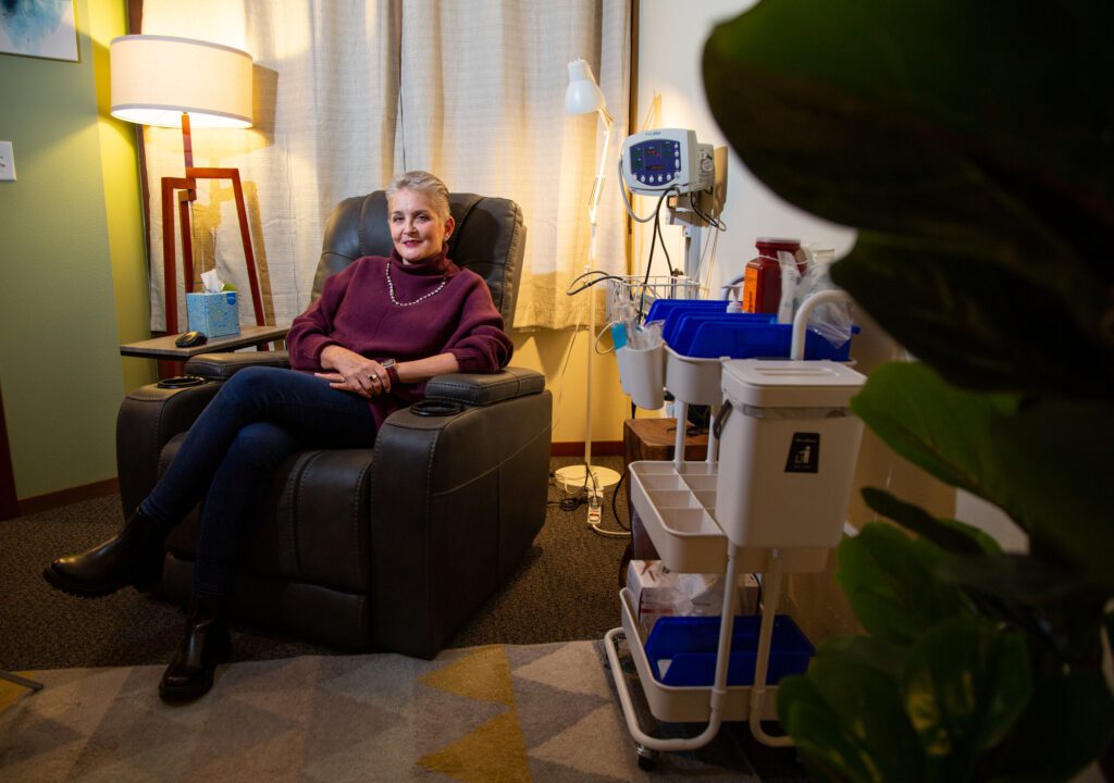 Dana Berger sits in a recliner next to carts of medical equipment at King Health.