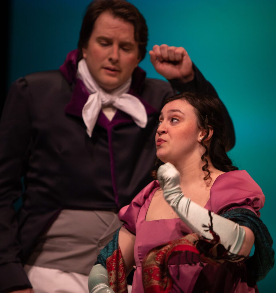 Mr. Darcy (Kyle Kahklen) and Elizabeth Bennet (Hannah Cafarella) perform on stage in costume.