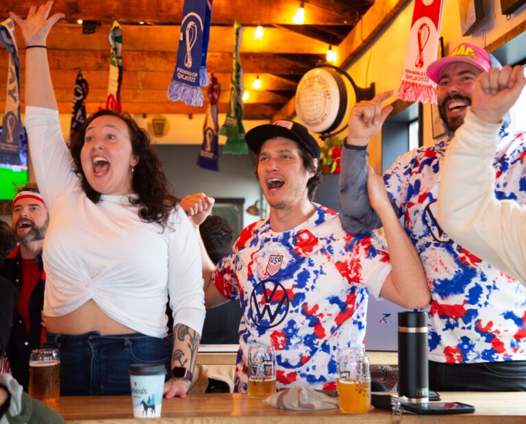 From left, Hanna McIlvaine, Cory James and Connor Adams celebrate a U.S. win over Iran at Gruff Brewing's World Cup watch party.