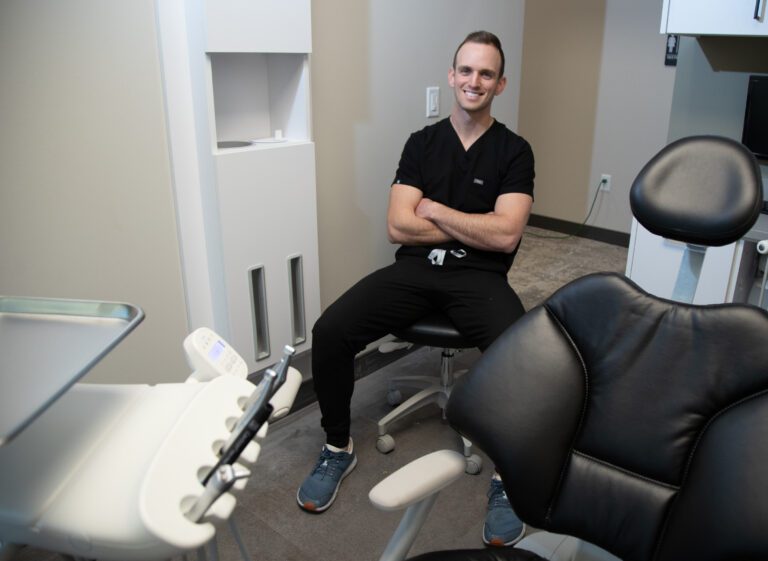 Chaz Vittitow, owner of The Local Dentist, sits inside a patient examination room.