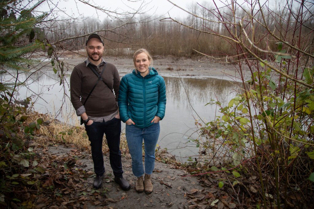 Conservation director Alex Jeffers, left, and communications director Claire Johnston stand on the bank of the Whatcom Land Trust's newest land purchase.