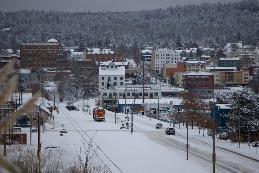 A layer of snow covers Bellingham and surrounding areas as cars carefully navigate the snowy roads.