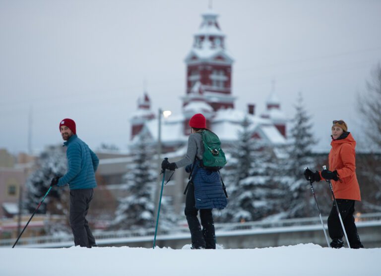 From left, Robin Helms, Brigitte Coan and Monte traverse the snow-covered pump track on cross-country skis.