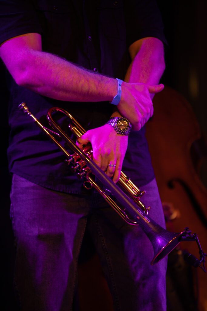 Kevin Woods waits during intermission with his trumpet.