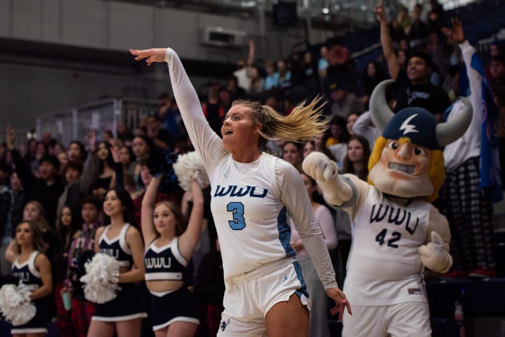 Western sophomore guard Riley Dykstra watches the ball after shooting as the crowd behind her reacts.