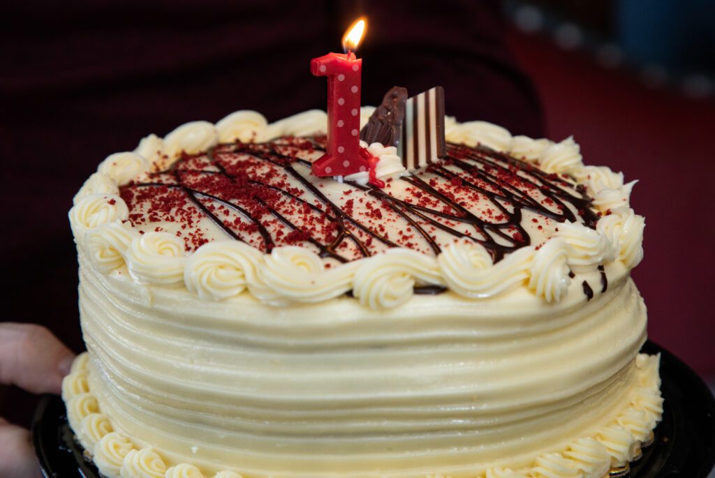 A cake with the number one candle.