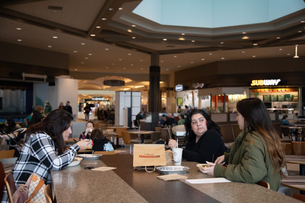 From left, sisters Melissa Bowe, Jessica Tagman and Erika Escareno eat Chipotle at one of the many tables in Bellis Fair's food court.