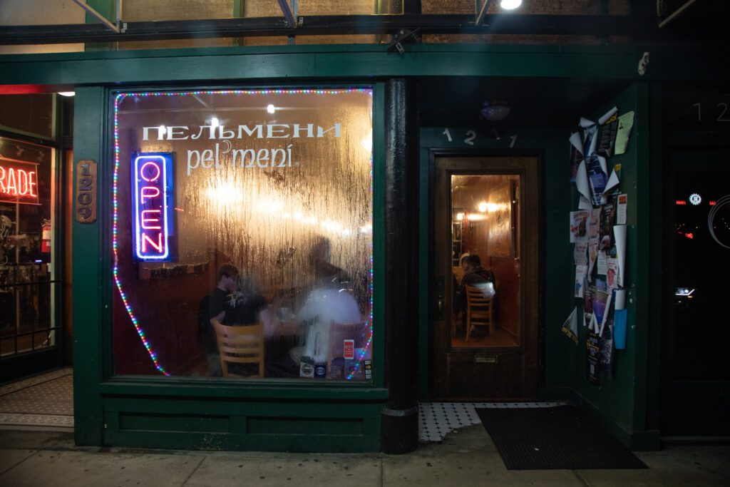 Steam clouds the window of Pel'meni with customers enjoying the drinks and food inside.