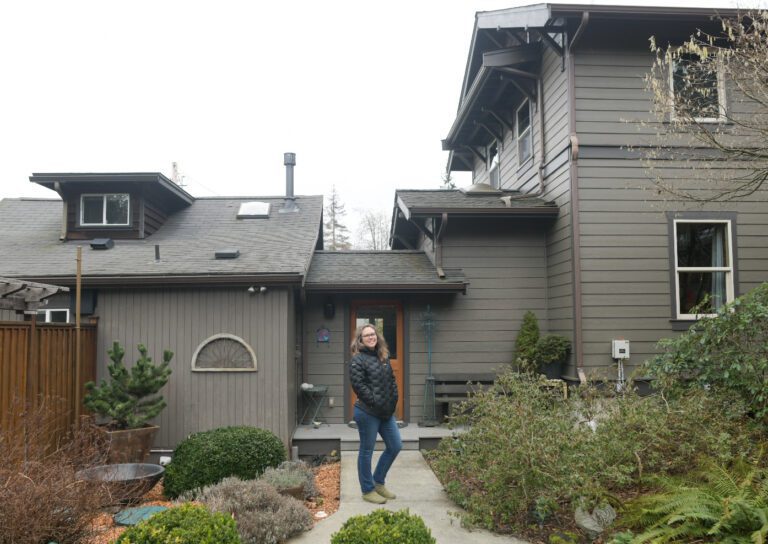 Crina Hoyer stands in front of her 600-square-foot attached accessory dwelling unit (ADU).